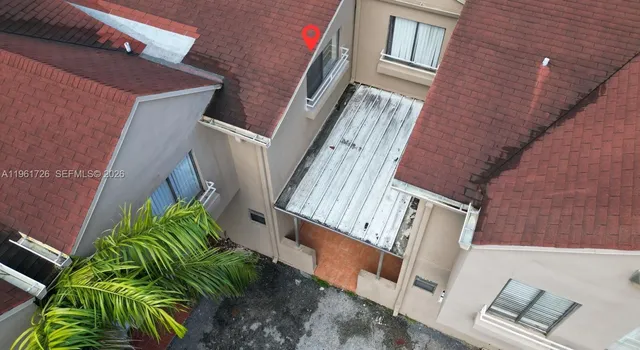 an aerial view of a house with a yard