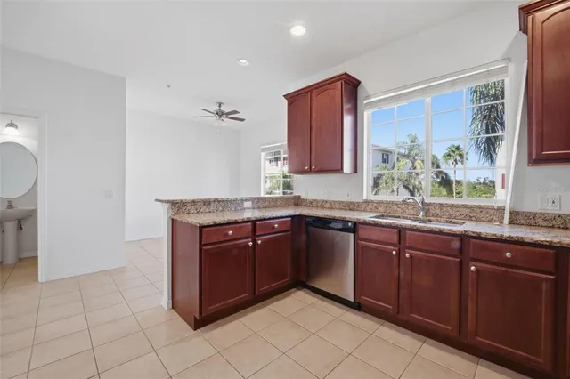 a kitchen with stainless steel appliances granite countertop a sink and a stove