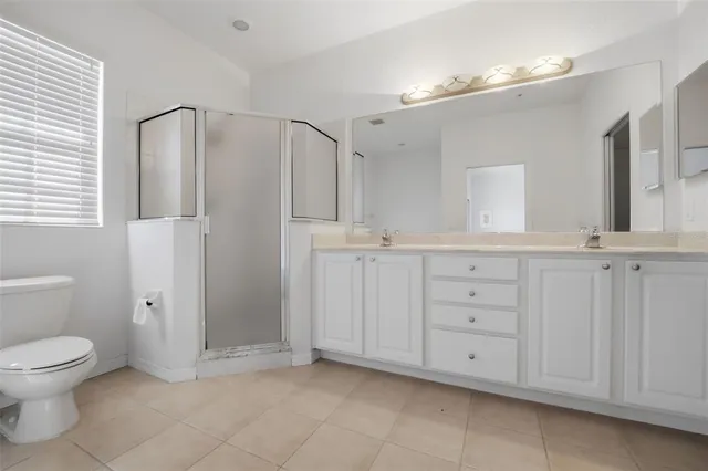a bathroom with a granite countertop sink mirror and toilet