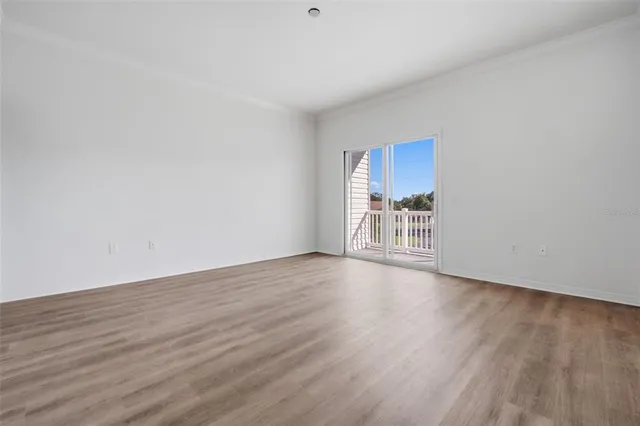 a view of a room with wooden floor and window
