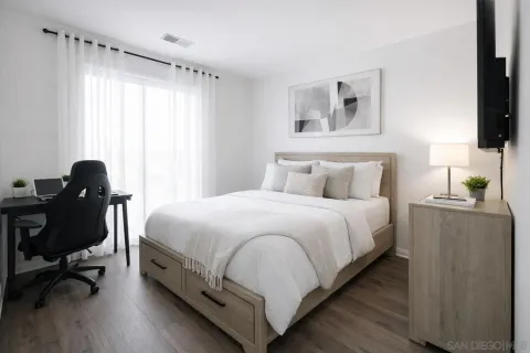 a bedroom with a bed and a window