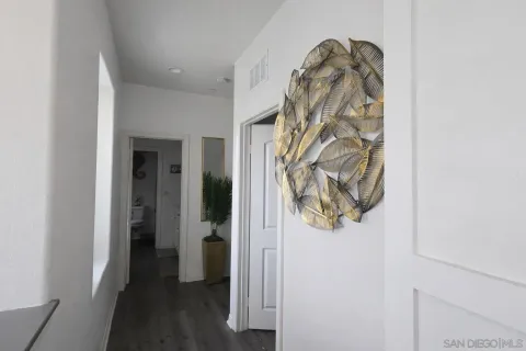 view of a hallway with wooden floor and closet
