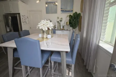 a dining room with furniture and potted plants