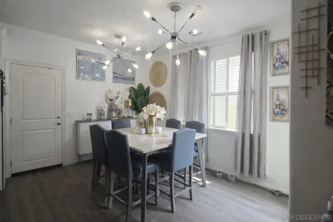 a view of a dining room with furniture and chandelier