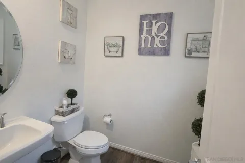 a white toilet sitting next to a bathroom sink