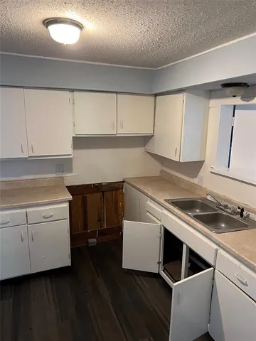 a kitchen with a stove and white cabinets