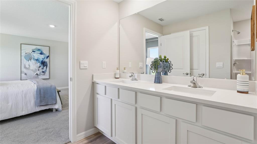13260 Southwest 56th Terrace Ocala, FL 34473 - Photo 19 of 30 a bathroom with double vanity sink and a mirror