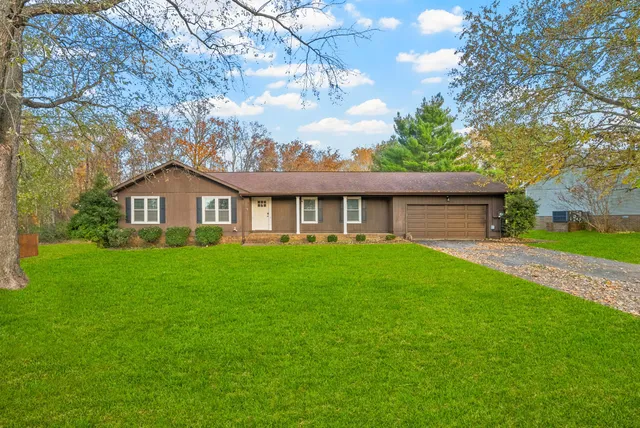 a front view of house with yard and green space
