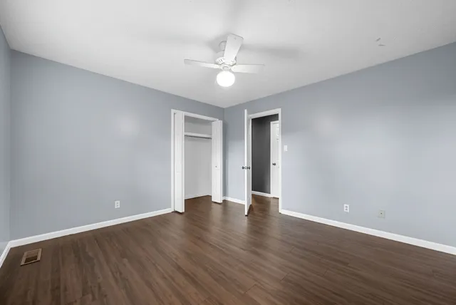 a view of an empty room with wooden floor