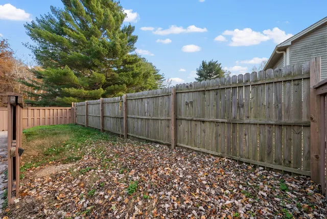 a view of a backyard with wooden fence