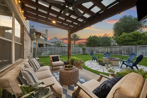 a patio with patio couch and outdoor seating