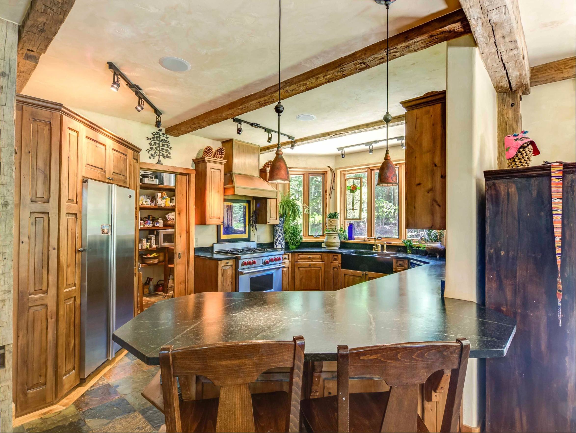 44 Spruce Way Telluride, CO 81435 - Photo 12 of 17 a dining table with floor to ceiling windows and dining room view