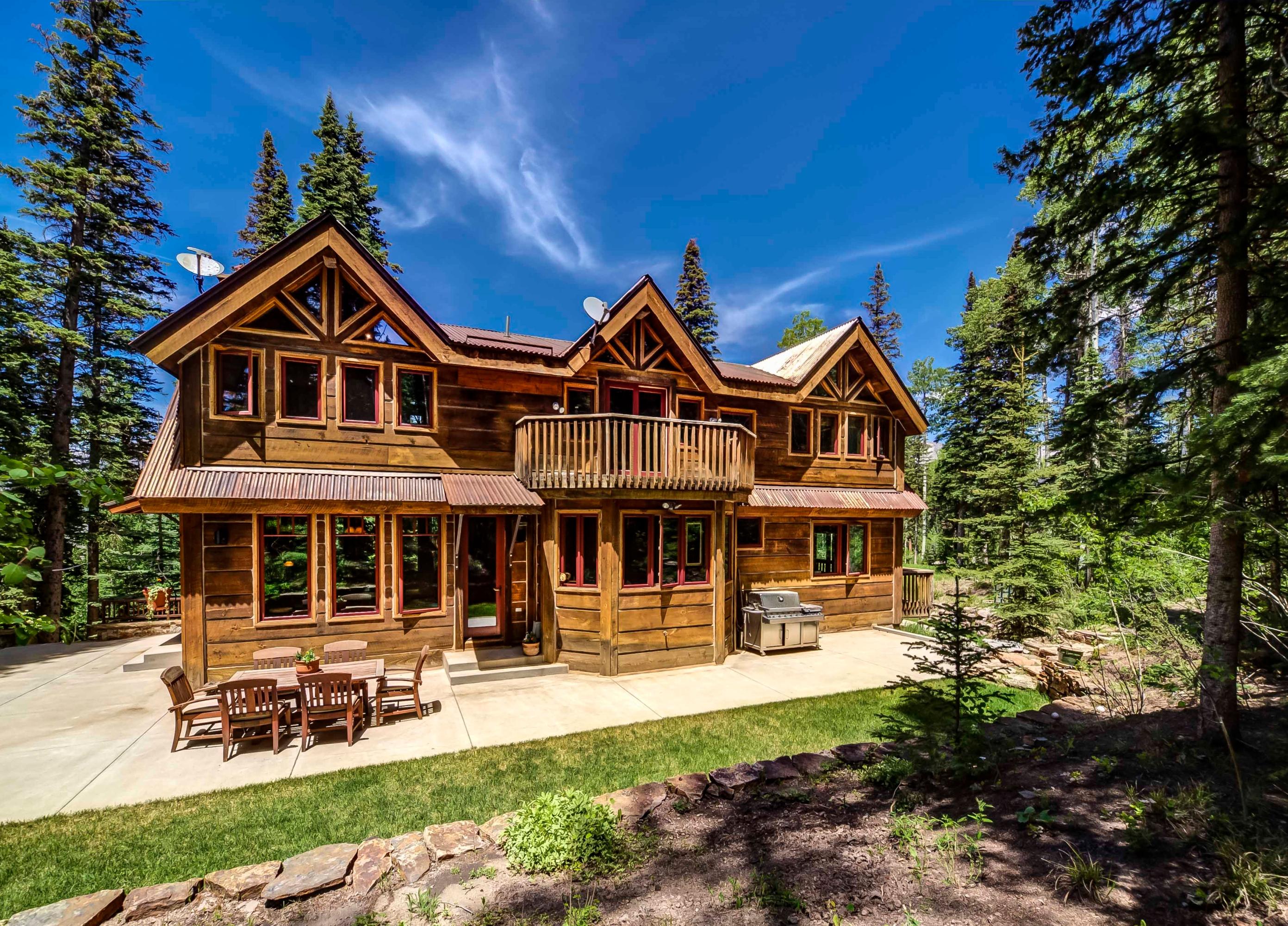 44 Spruce Way Telluride, CO 81435 - Photo 3 of 17 a front view of a house with garden and porch