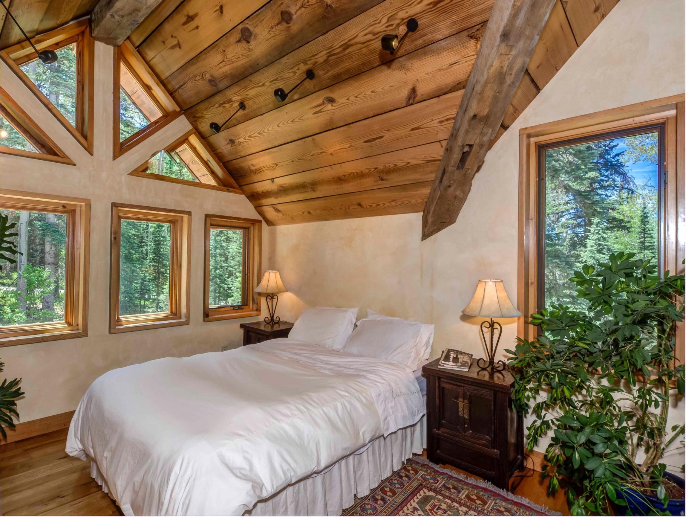 44 Spruce Way Telluride, CO 81435 - Photo 8 of 17 a large bed sitting in a bedroom next to a window