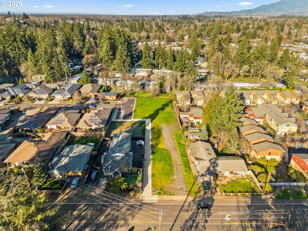 an aerial view of residential houses with outdoor space and swimming pool