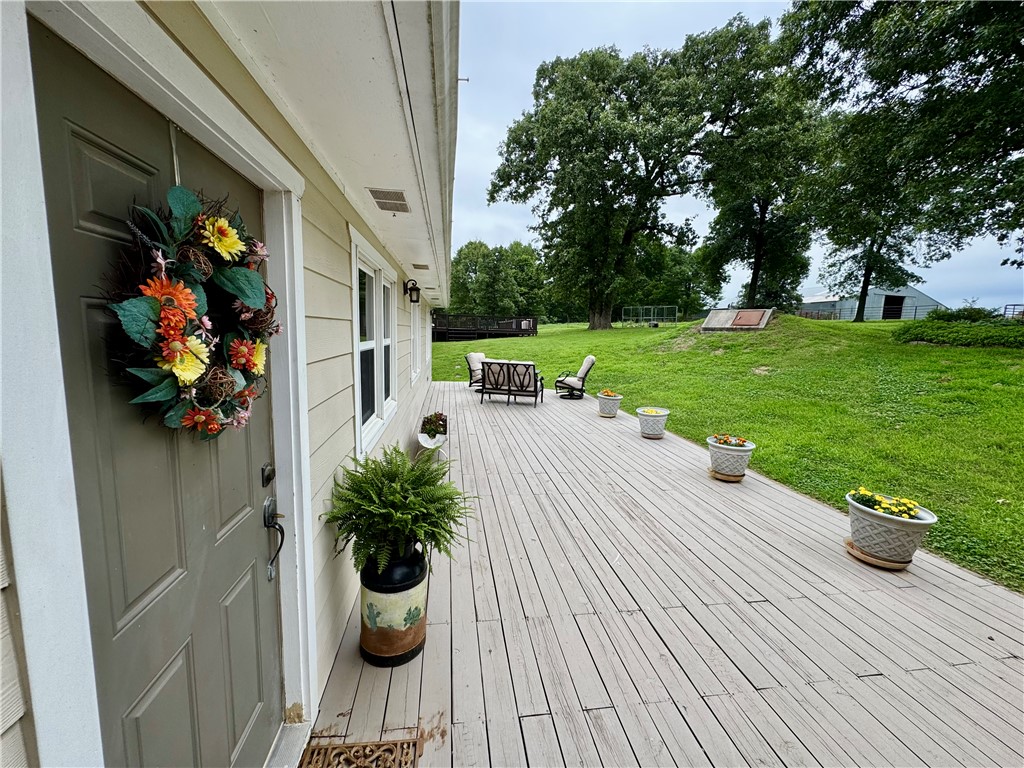 15196 Cincinnati Creek Road Summers, AR 72769 - Photo 29 of 42 Exterior wood deck extending from the residence, featuring horizontal planking and a spacious layout
