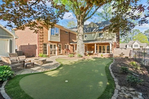 a outdoor space with patio the couches and dining table with a garden view
