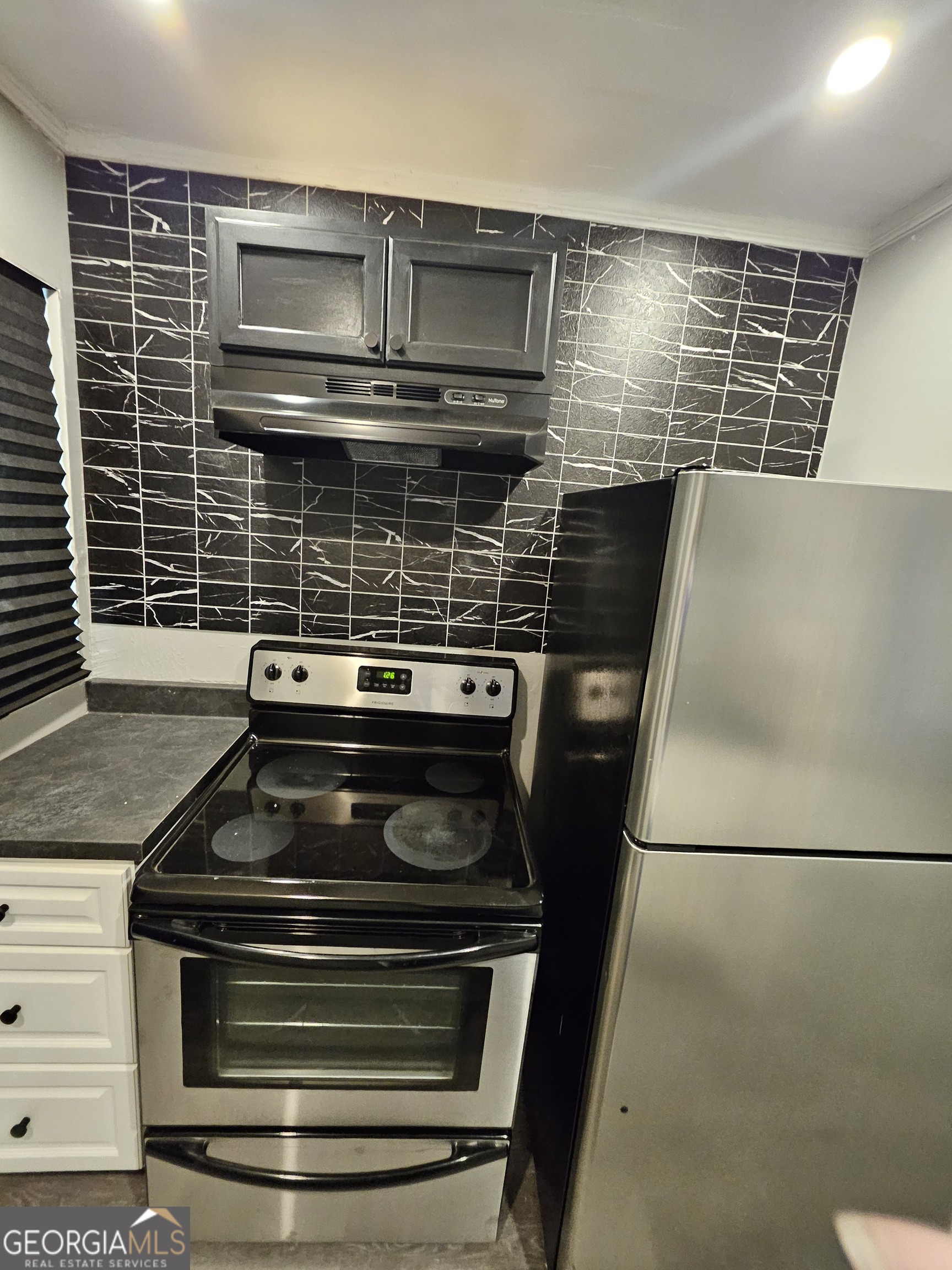 521 Meriwether Street, Unit A Griffin, GA 30224 - Photo 8 of 12 a stove top oven sitting inside of a kitchen