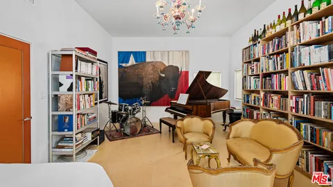 a living room with lots of furniture and a book shelf