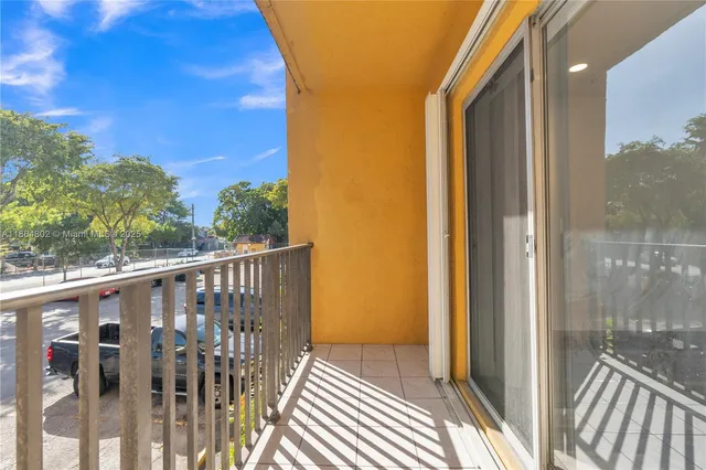a view of a balcony with wooden floor and fence