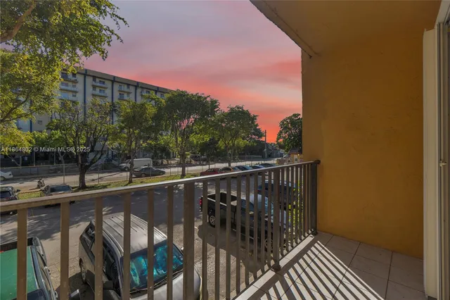a view of balcony with wooden floor and fence