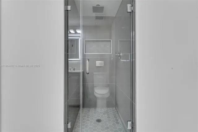 a bathroom with a glass shower door