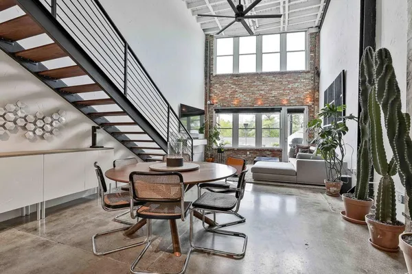 a dining room with furniture and a floor to ceiling window
