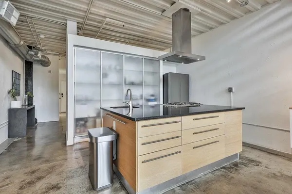 a kitchen with stainless steel appliances granite countertop a sink and cabinets