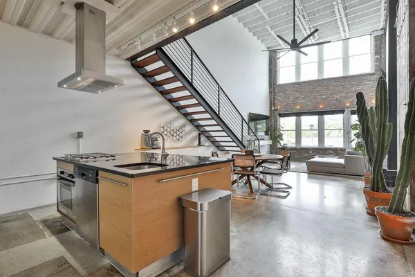 a kitchen with stainless steel appliances granite countertop a stove and a refrigerator