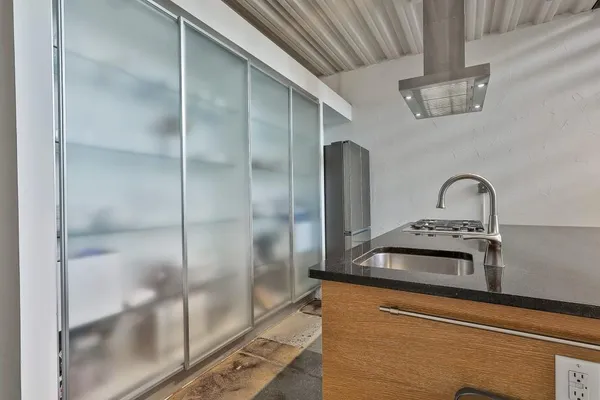 a close view of a sink and a refrigerator