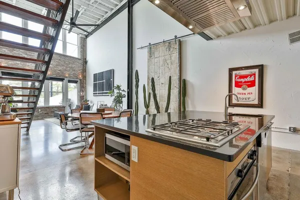 a kitchen with stainless steel appliances granite countertop a stove and a refrigerator