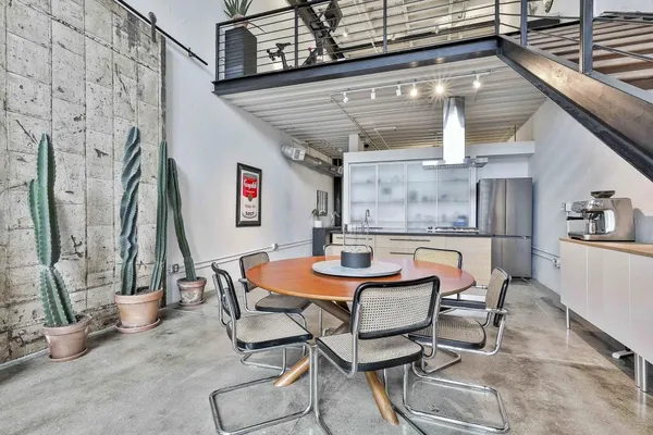 a dining room with furniture and a kitchen view