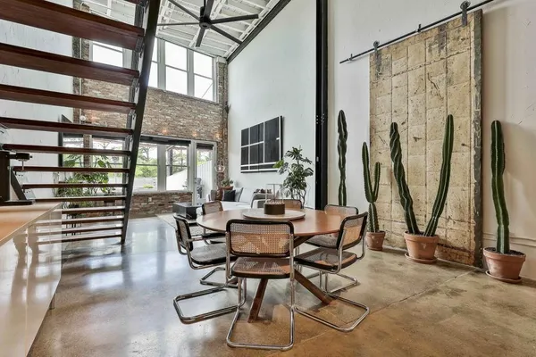a dining room with furniture and a floor to ceiling window