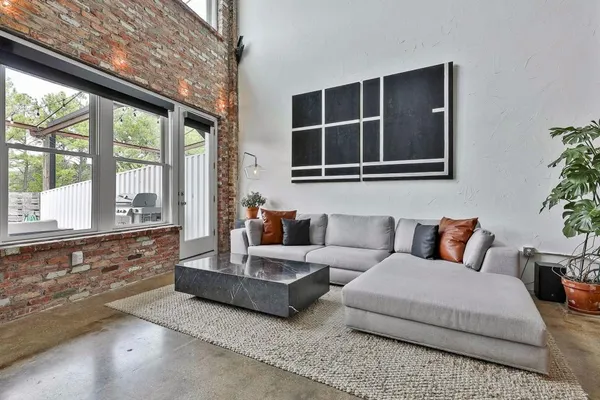 a living room with furniture and windows