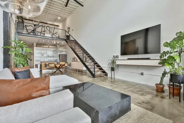 a living room with furniture and a potted plant