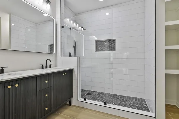 a bathroom with a shower sink and mirror