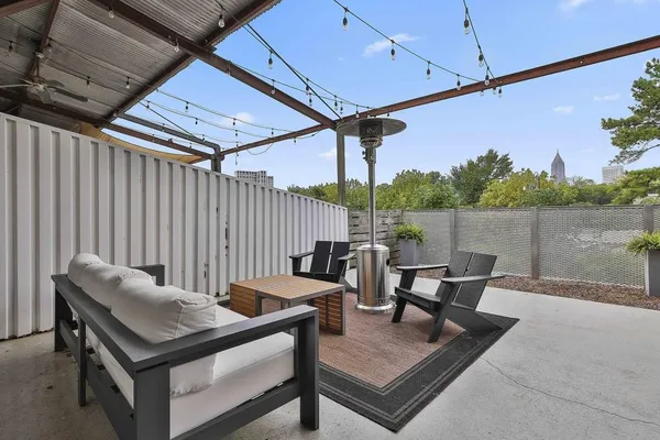 a roof deck with a table and chairs