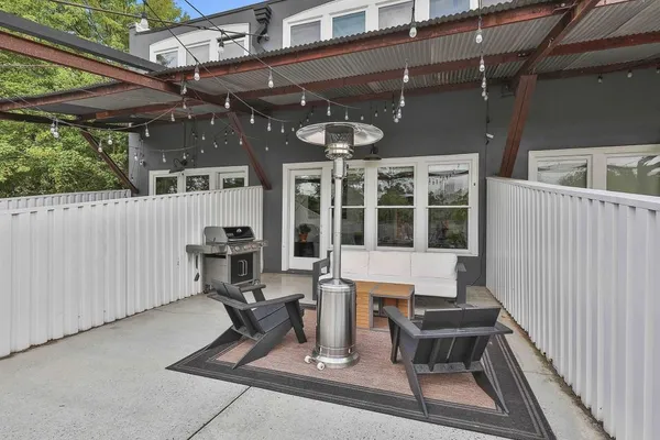 a view of a patio with table and chairs with wooden floor
