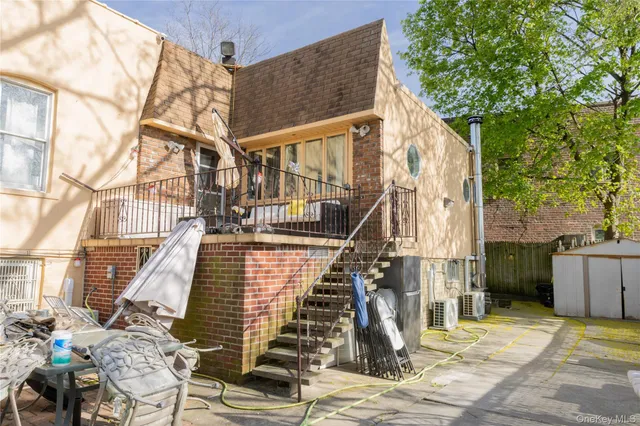 a view of a brick house with large windows