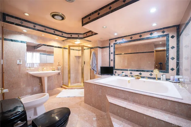 a bathroom with a double vanity sink mirror and toilet