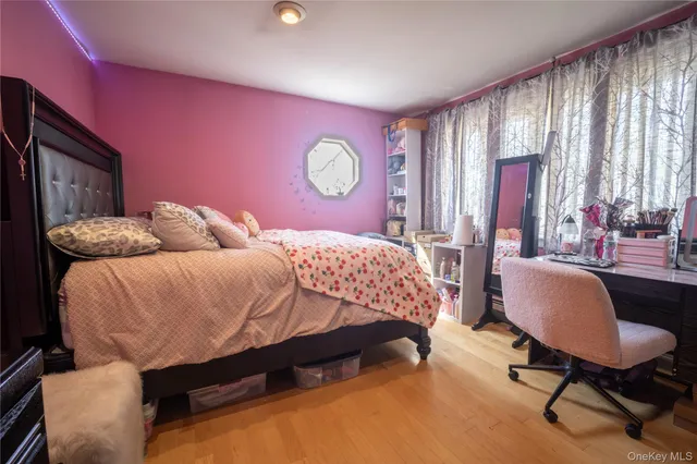 a bedroom with a bed chair and window