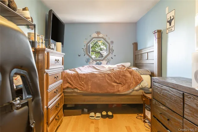 a bed sitting in a bedroom next to a window