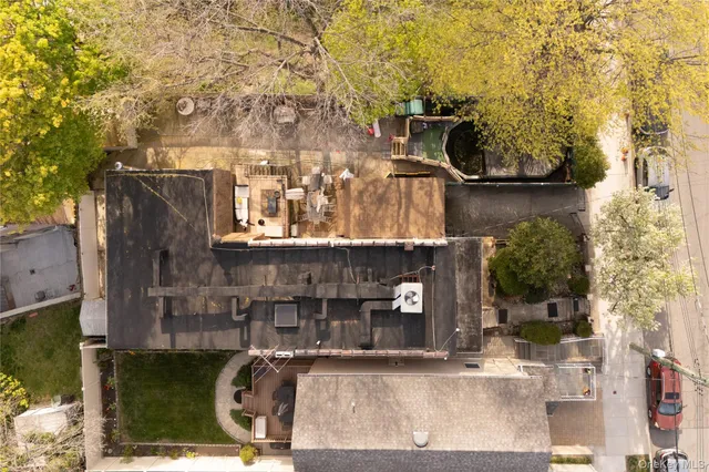 an aerial view of a house with a yard