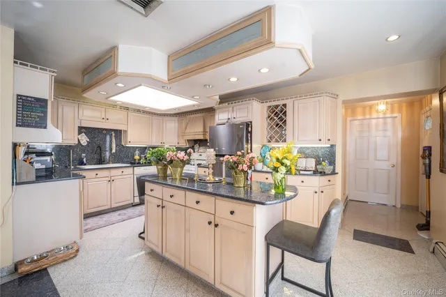 a kitchen with counter and chairs