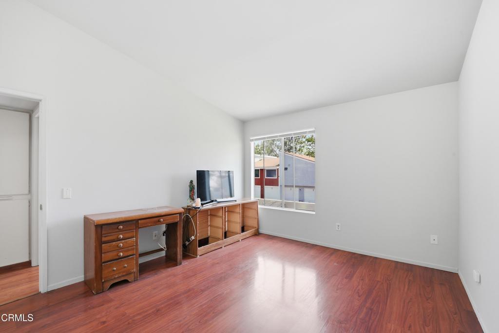 5154 Jefferson Square Oxnard, CA 93033 - Photo 22 of 23 a room with wooden floors and a window