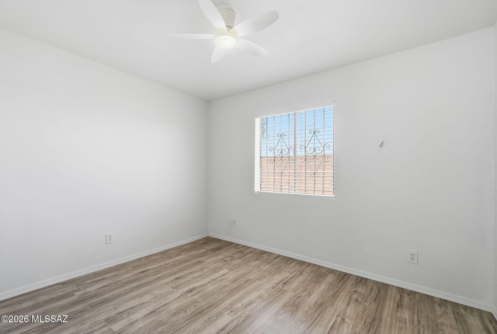 136 West Elvira Road Tucson, AZ 85756 - Photo 17 of 27 an empty room with a window and ceiling fan