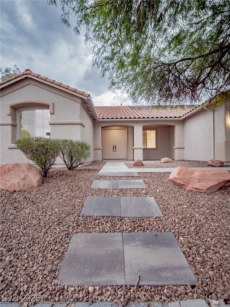 7870 Midnight Ride Street Las Vegas, NV 89131 - Photo 10 of 69 View of front of house with a tiled roof and stucco siding