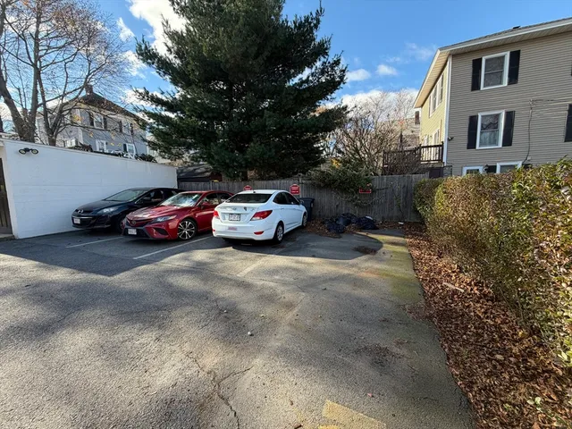 a car parked in front of a white house