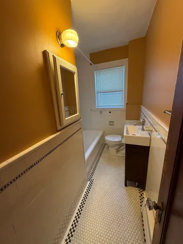 a bathroom with a sink a toilet and bathtub