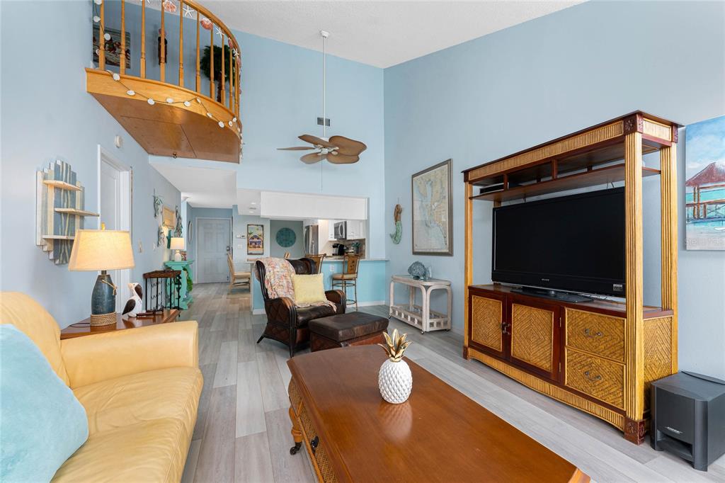 5031 North Beach Road, Unit 222 Englewood, FL 34223 - Photo 11 of 64 a living room with furniture and a flat screen tv